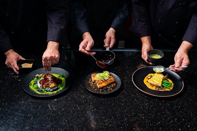 chefs adding toppings to plates