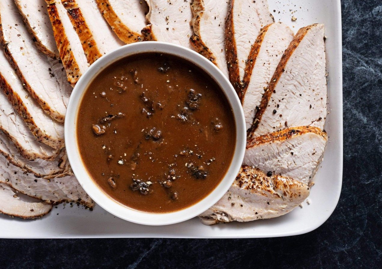 Morel Sauce in dipping container on sliced turkey