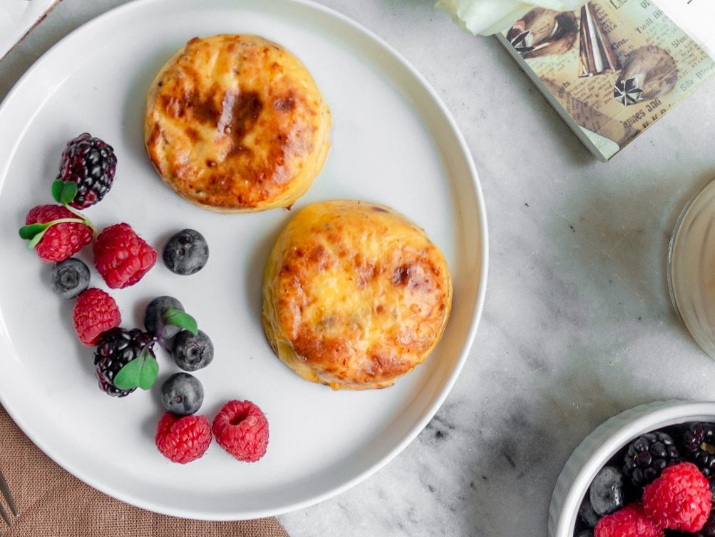 Bacon & Cheddar Cheese bites with raspberries and blueberries on a plate