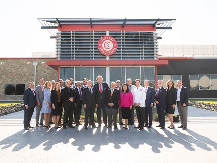 Group shot of employees in front of new facility