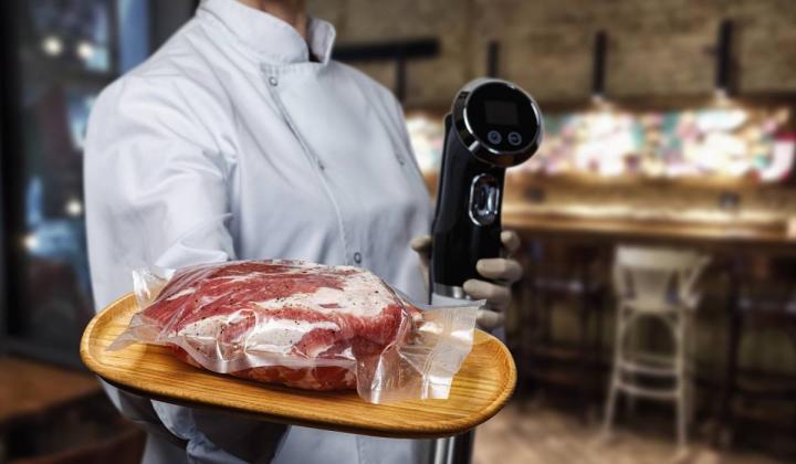 Chef holding beef in a sous vide bag