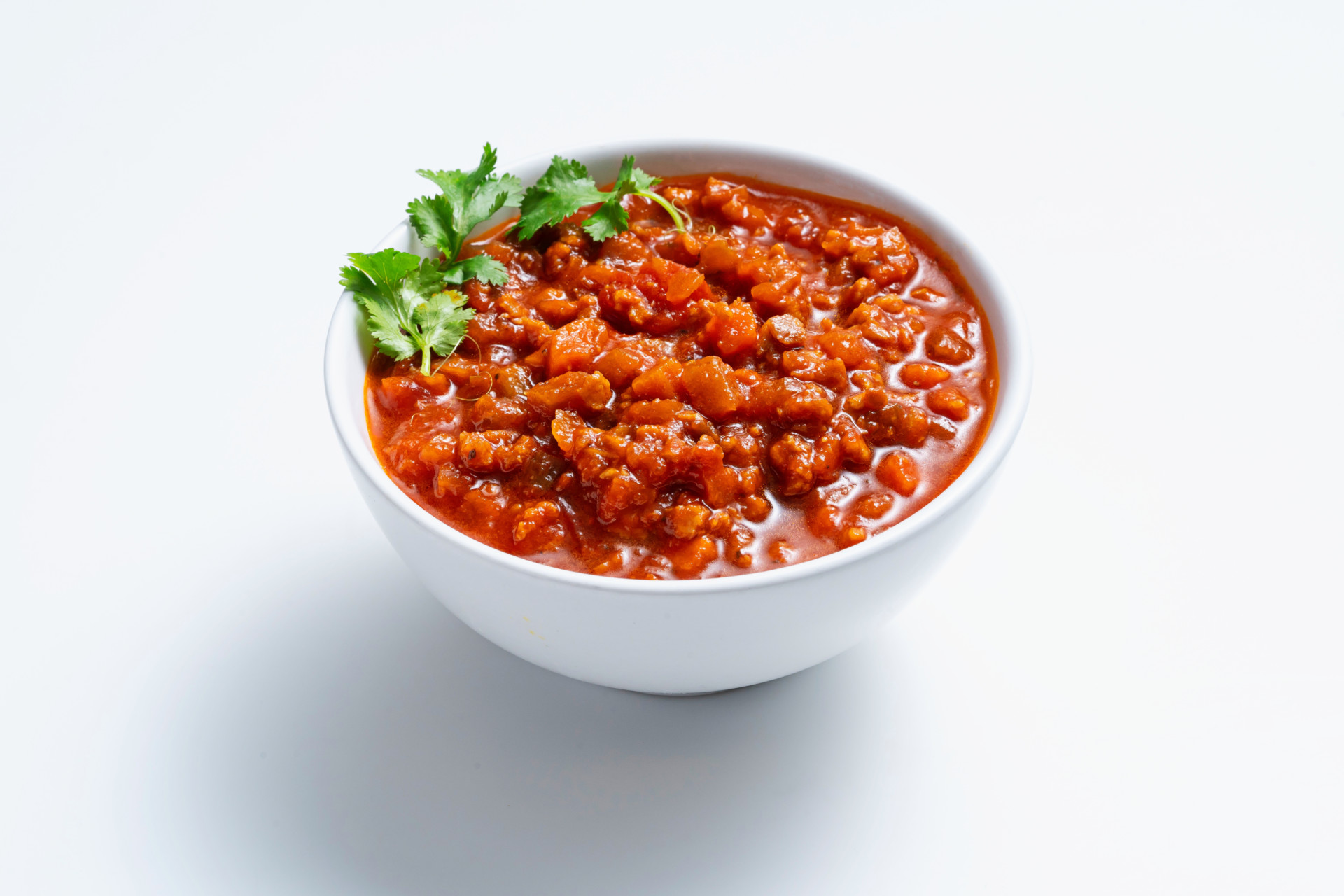 Vegan Bolognese in a bowl with cilantro garnish