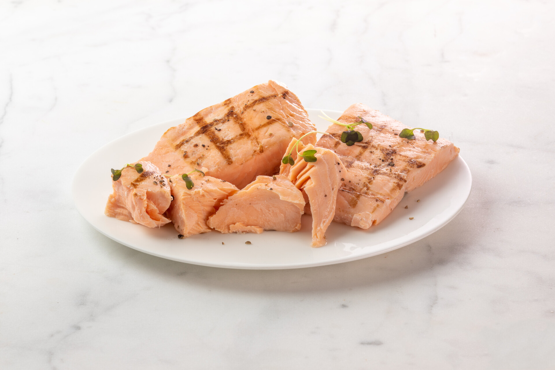 grilled salmon chunks on white plate